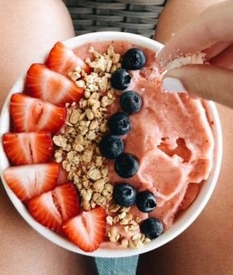 bowl of porridge with strawberries, blueberries 